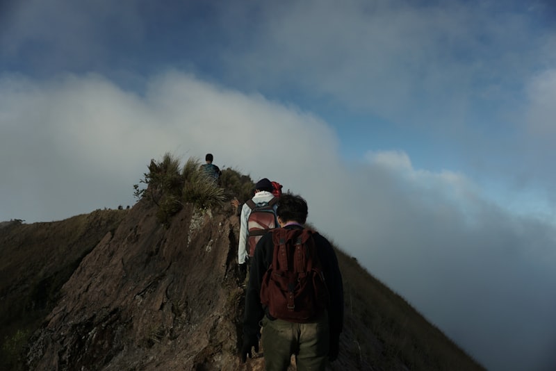 Hikers trekking up Mt Batur volcano at sunrise in Bali