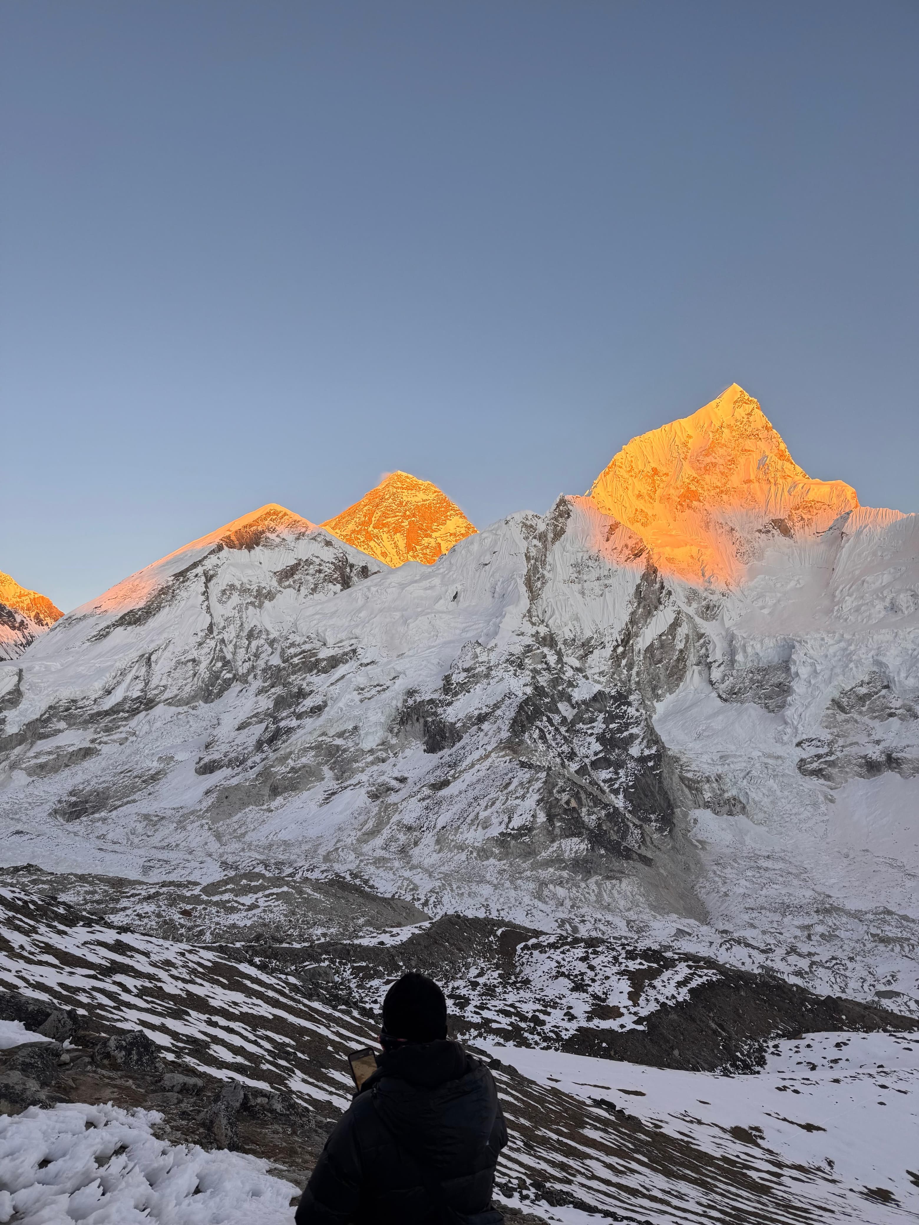 Sunrise casting golden light on Everest and Nuptse peaks